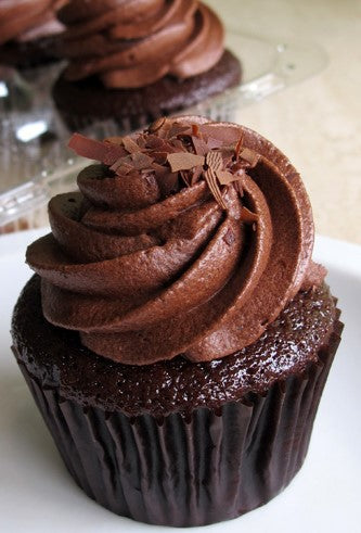 Unforgettable, light chocolate devil’s food cupcake, with whipped chocolate icing, and dark chocolate shavings.